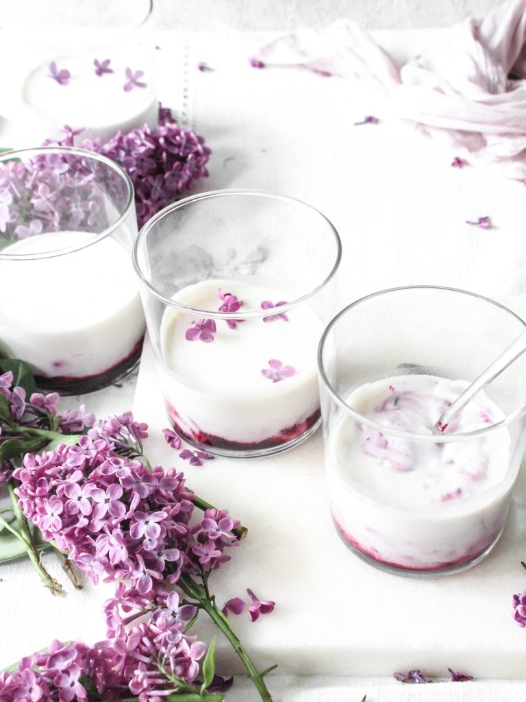Panna cotta, lilac flowers and blackcurrant